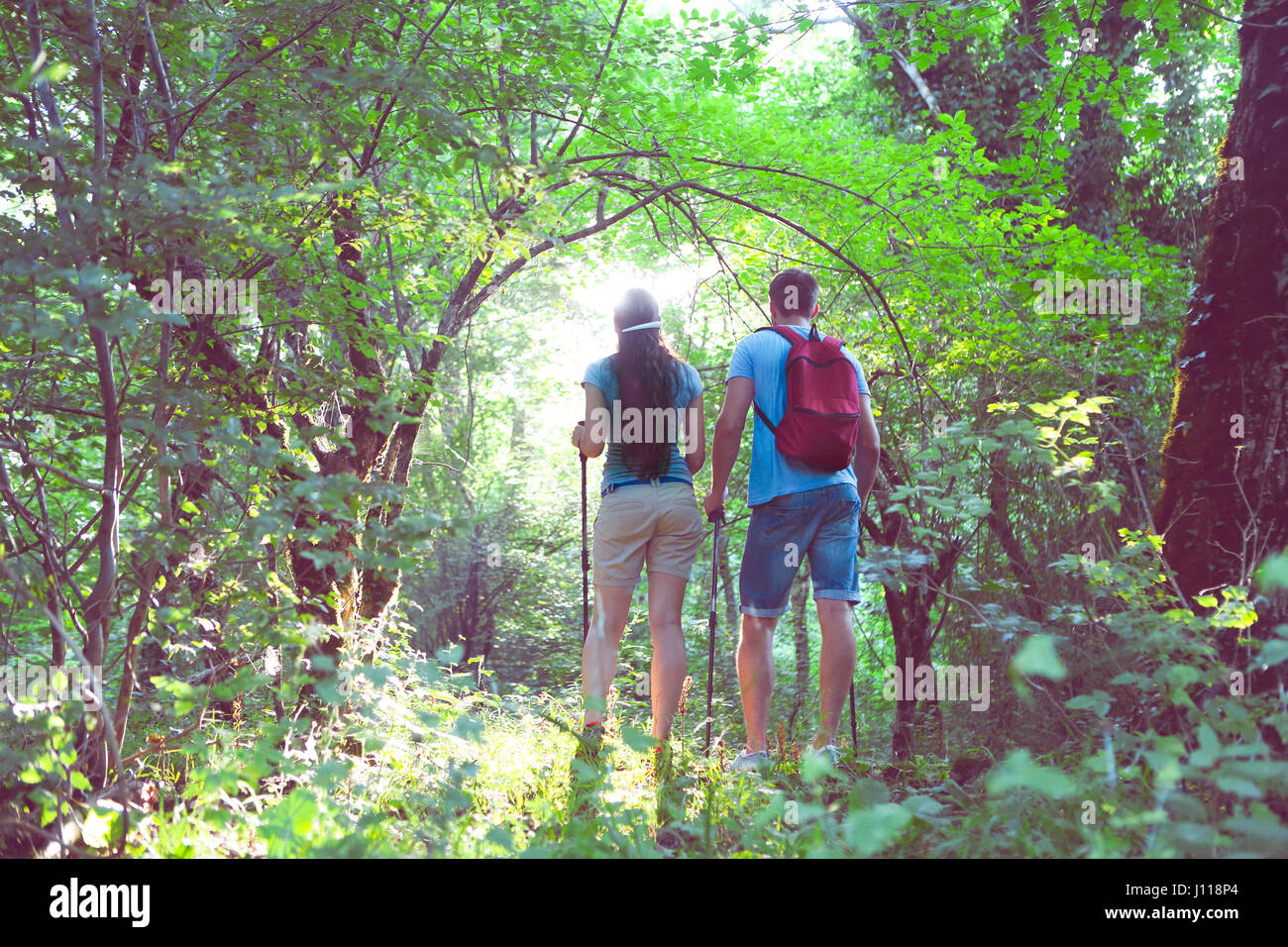 Young Backpackers Two young backpackers in the forest. Travel and summer vacation concept ...