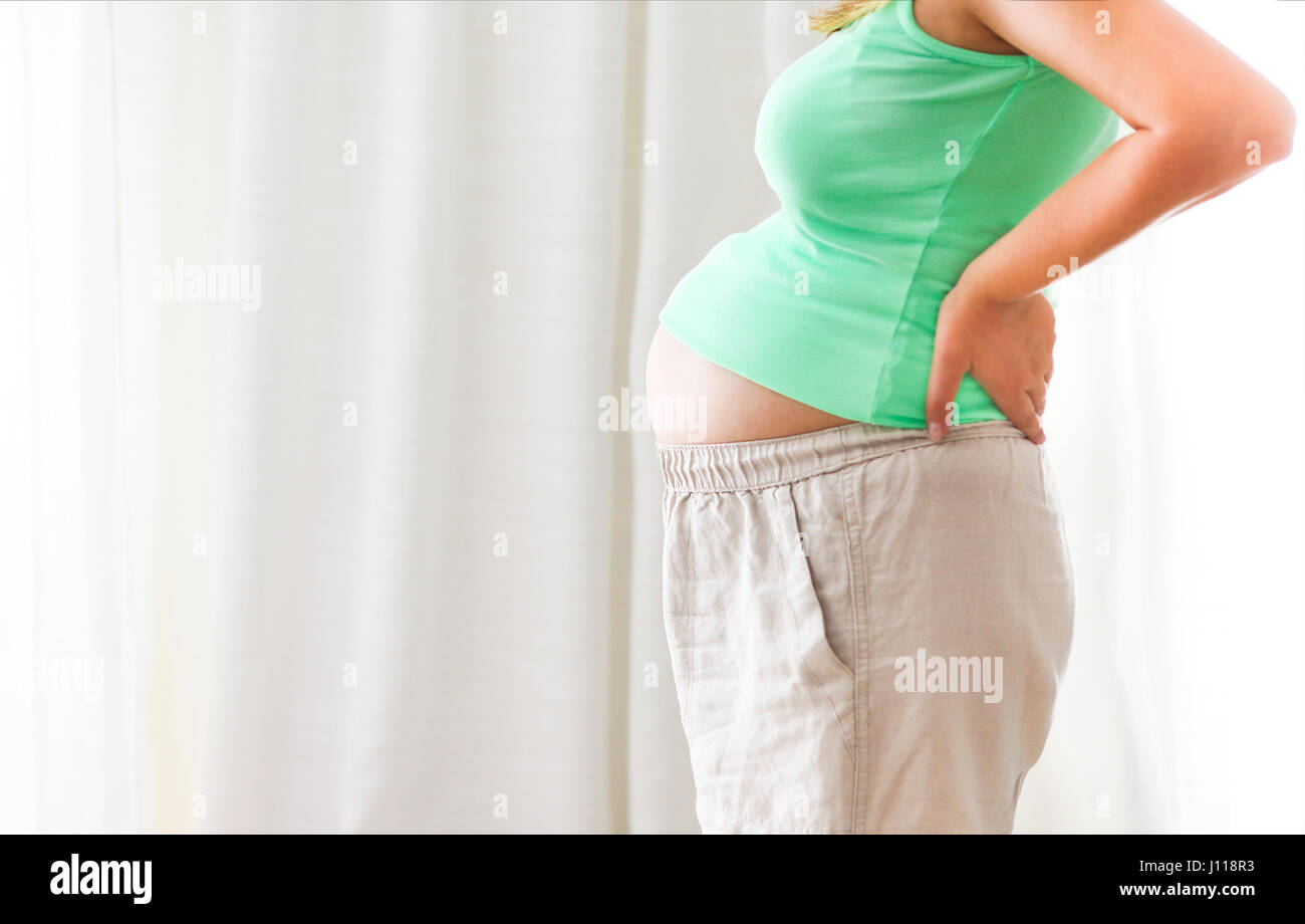 Pregnancy, motherhood- close up of happy pregnant woman indoors Stock Photo