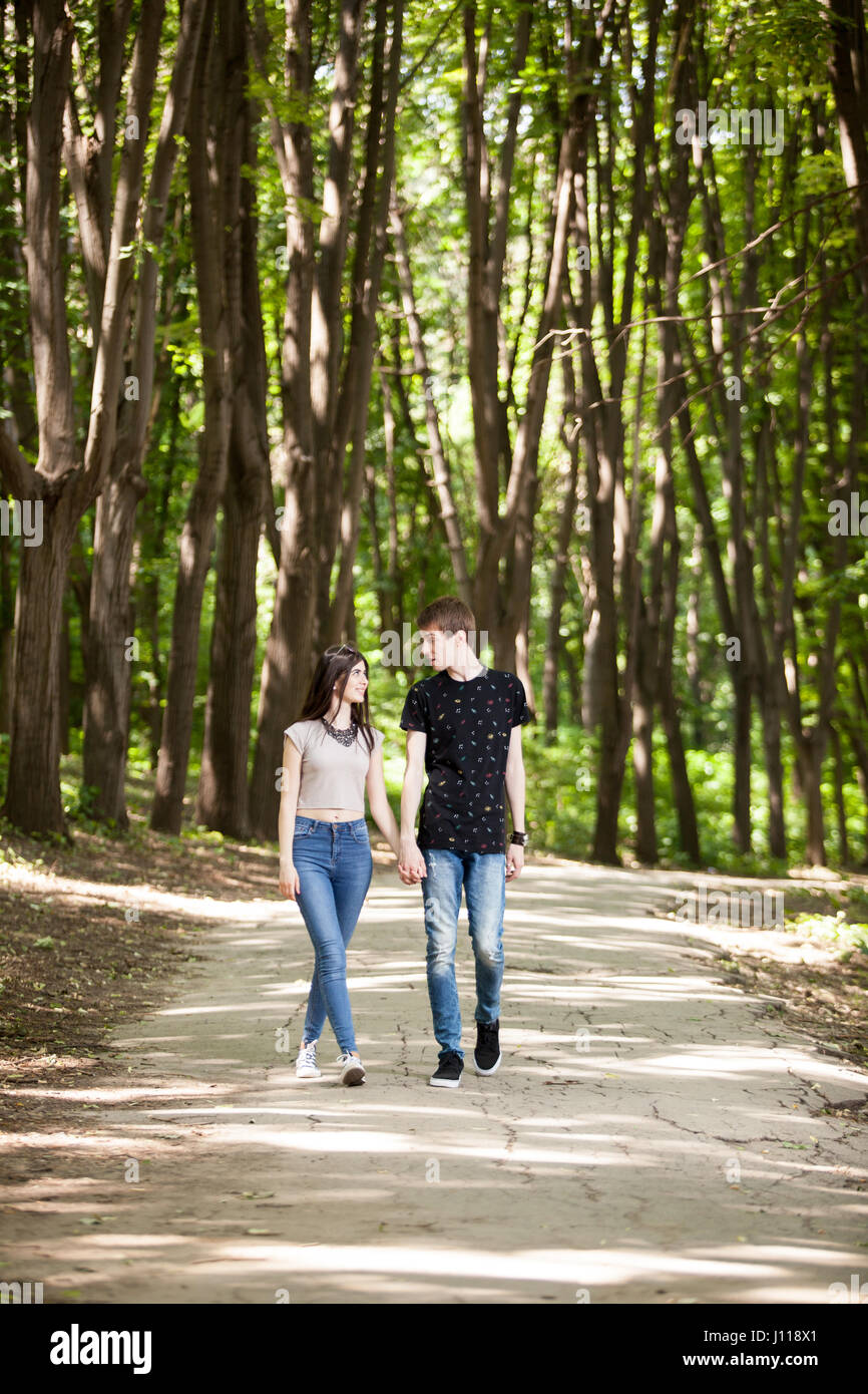 Happy couple taking a walk in the forest Stock Photo - Alamy