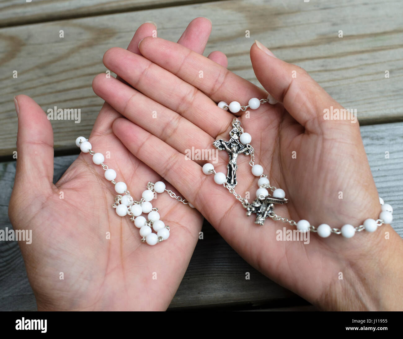 Rosary Beads on Hands Stock Photo