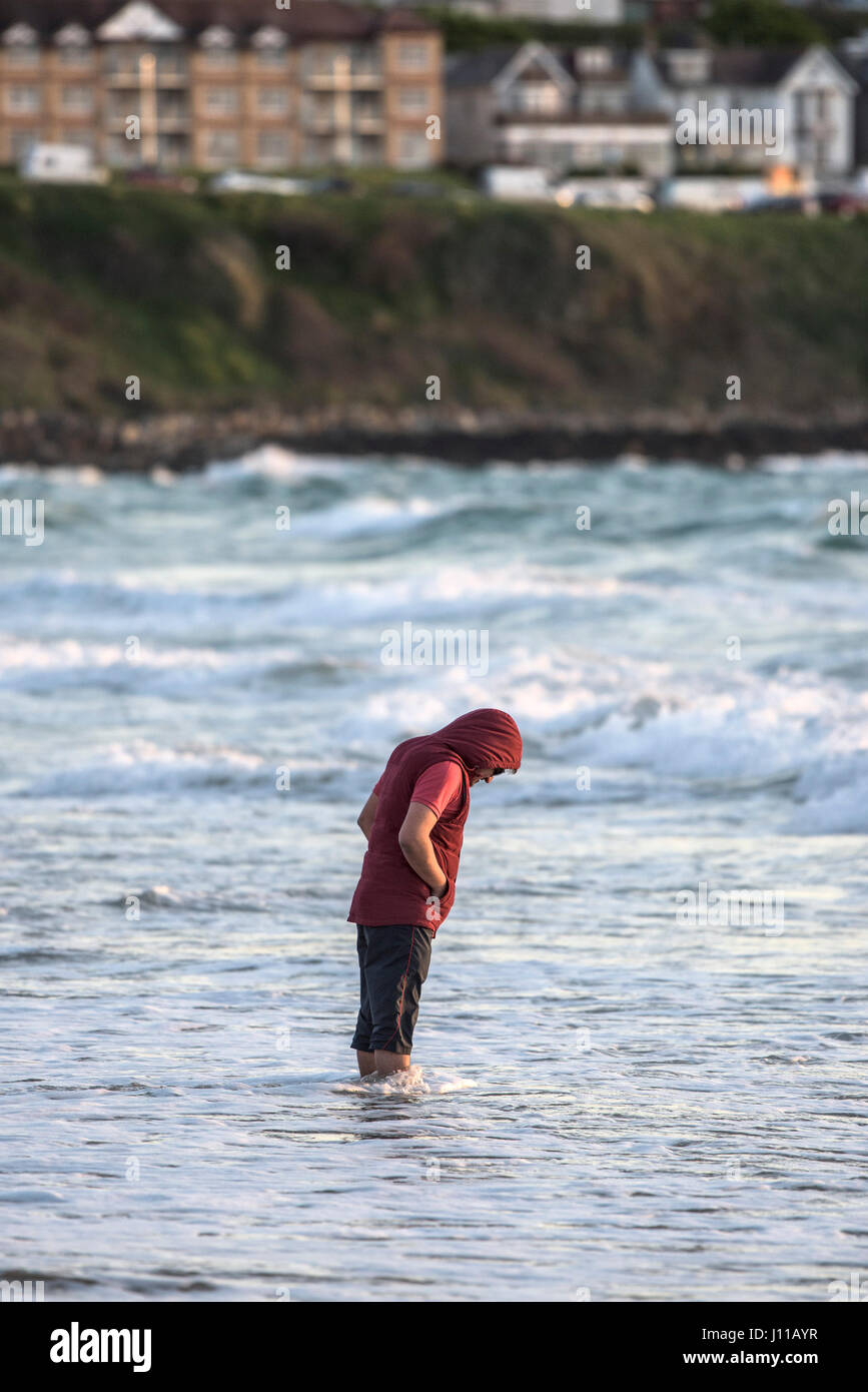 Fistral beach Man Standing in the sea Paddling Coast Coastal scene Tourism Cornwall Stock Photo