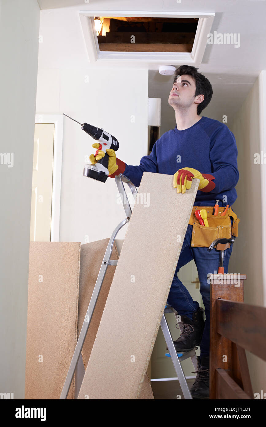 Workman Fitting Boards To Floor Of House Loft Stock Photo Alamy