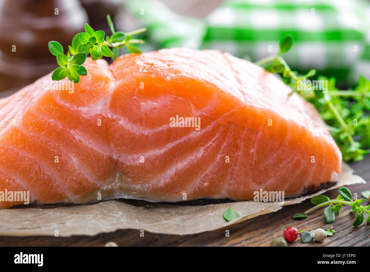 Raw salmon fish fillet on wooden board closeup Stock Photo - Alamy