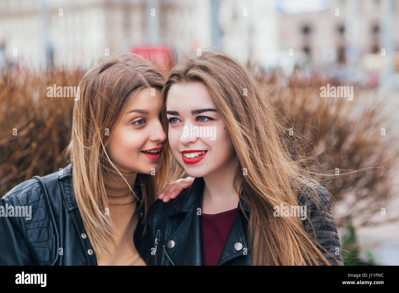 Friendship . Two Women Talking in the City Stock Photo