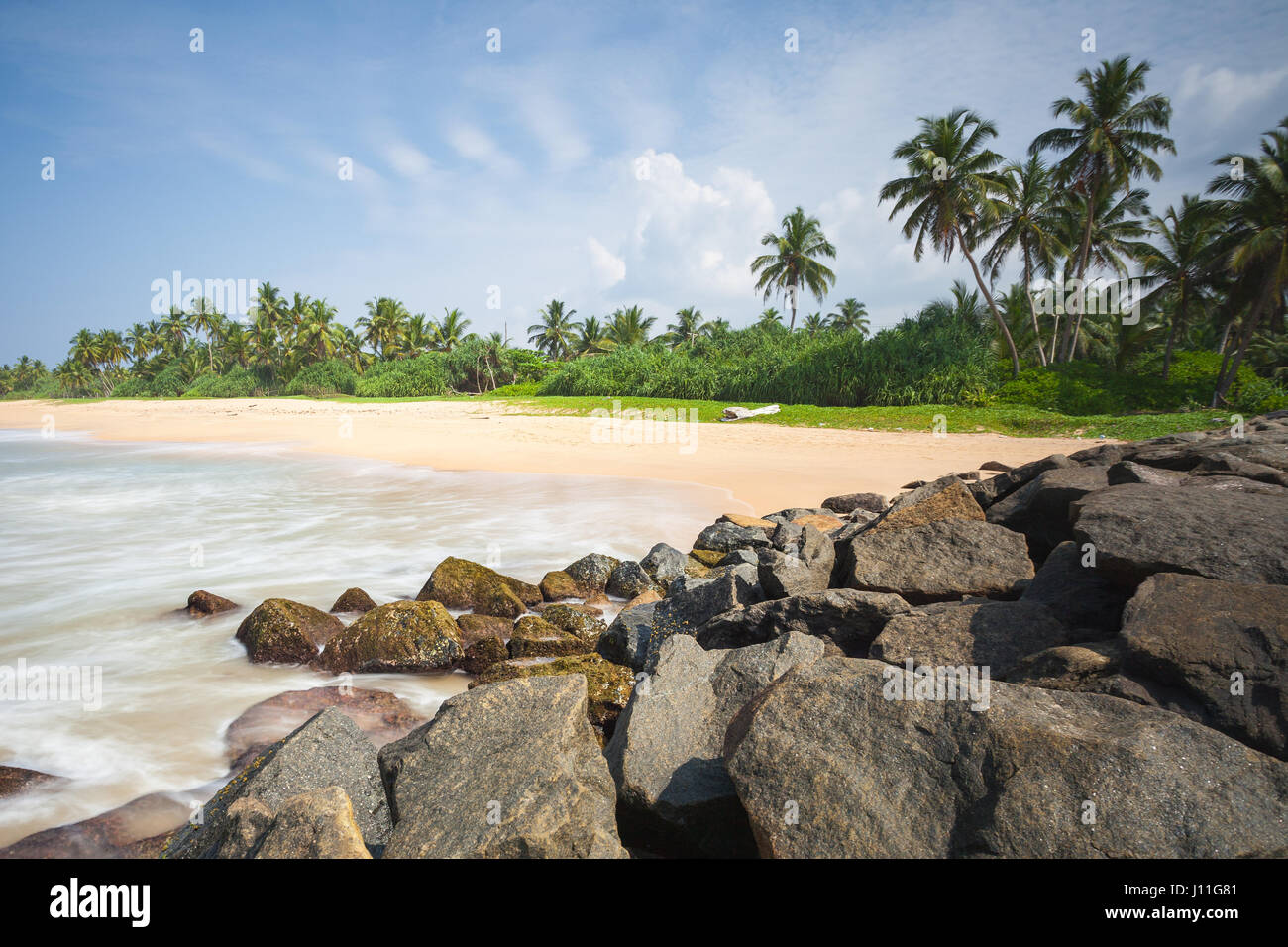 Great and beautiful place in paradise. Indian ocean with golden sand and palms in Sri Lanka. A wonderful nature landscape of a beach scene in Sri Lank Stock Photo