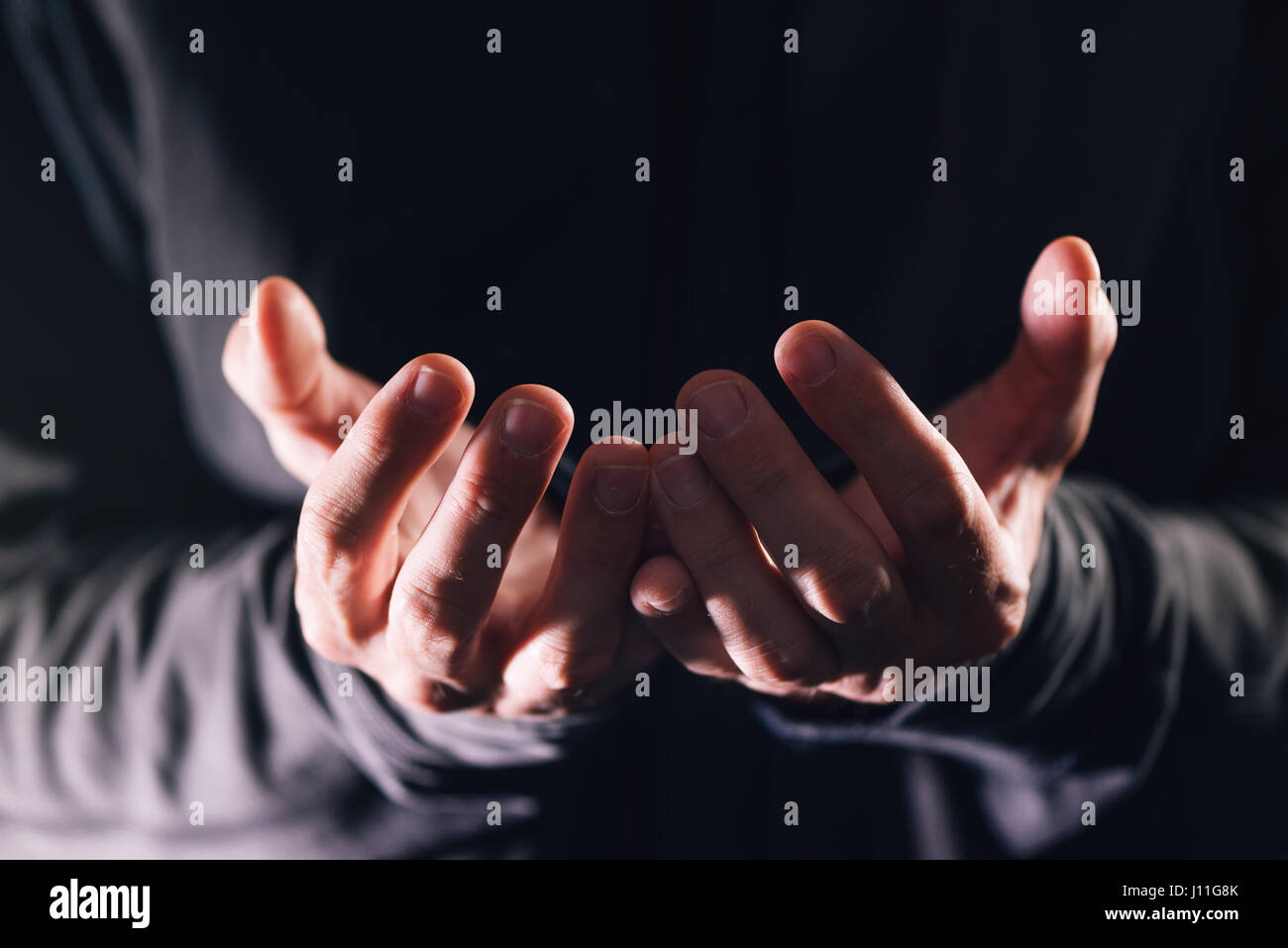 Cupped hands asking for money, poor male beggar needs charity and help Stock Photo