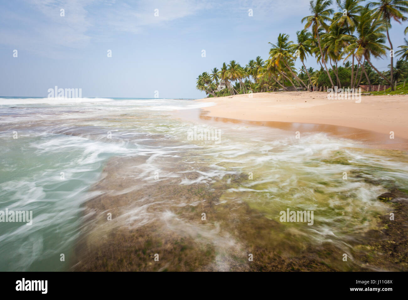 Great and beautiful place in paradise. Indian ocean with golden sand and palms in Sri Lanka. A wonderful nature landscape of a beach scene in Sri Lank Stock Photo