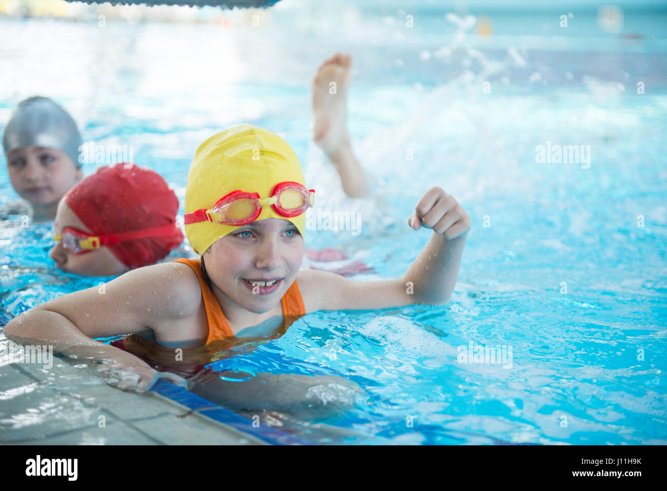 happy children kids group at swimming pool class learning to swim Stock ...