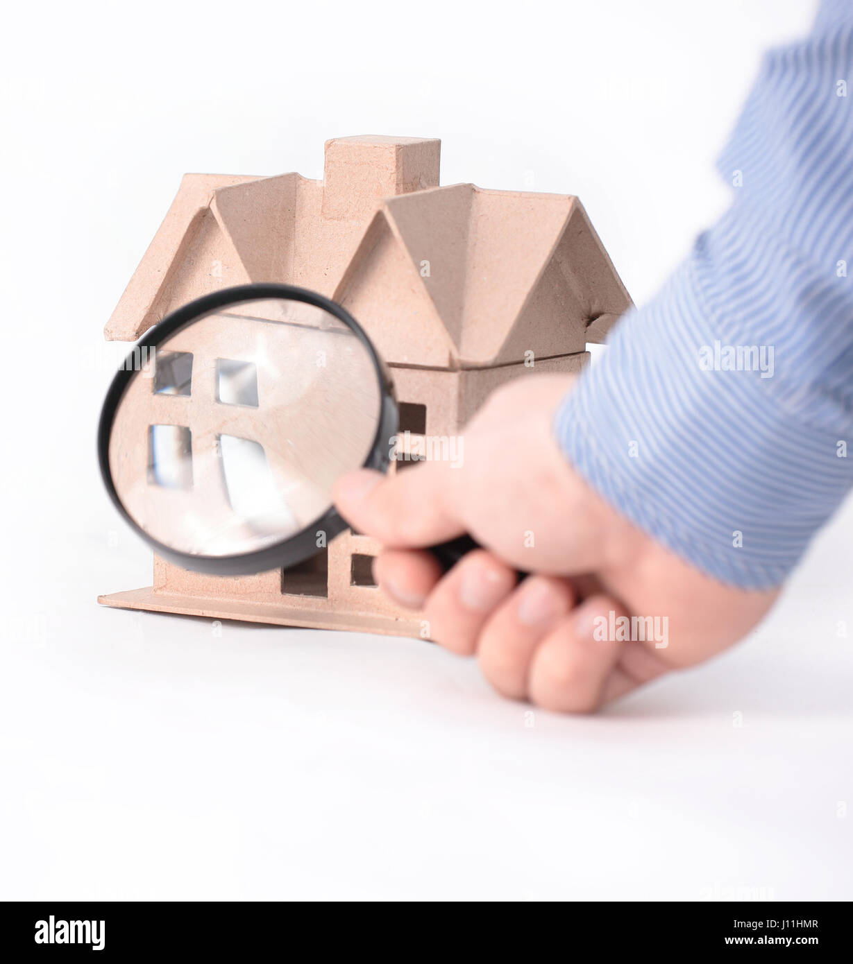 House architectural model under magnifying glass Stock Photo