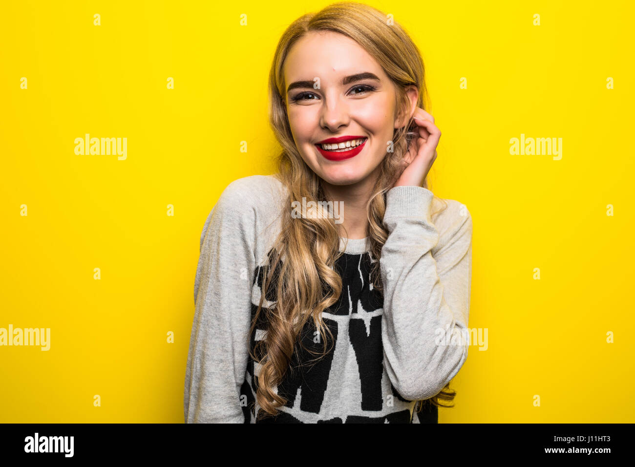 portrait of the beautiful woman on the yellow background Stock Photo ...