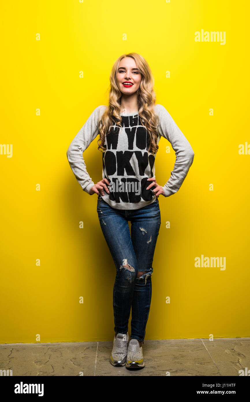 portrait of the beautiful woman on the yellow background Stock Photo ...