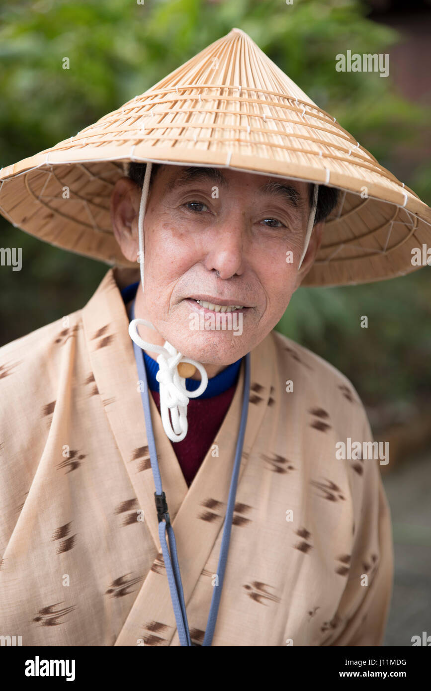 Elderly Okinawan man with traditional conical grass hat and