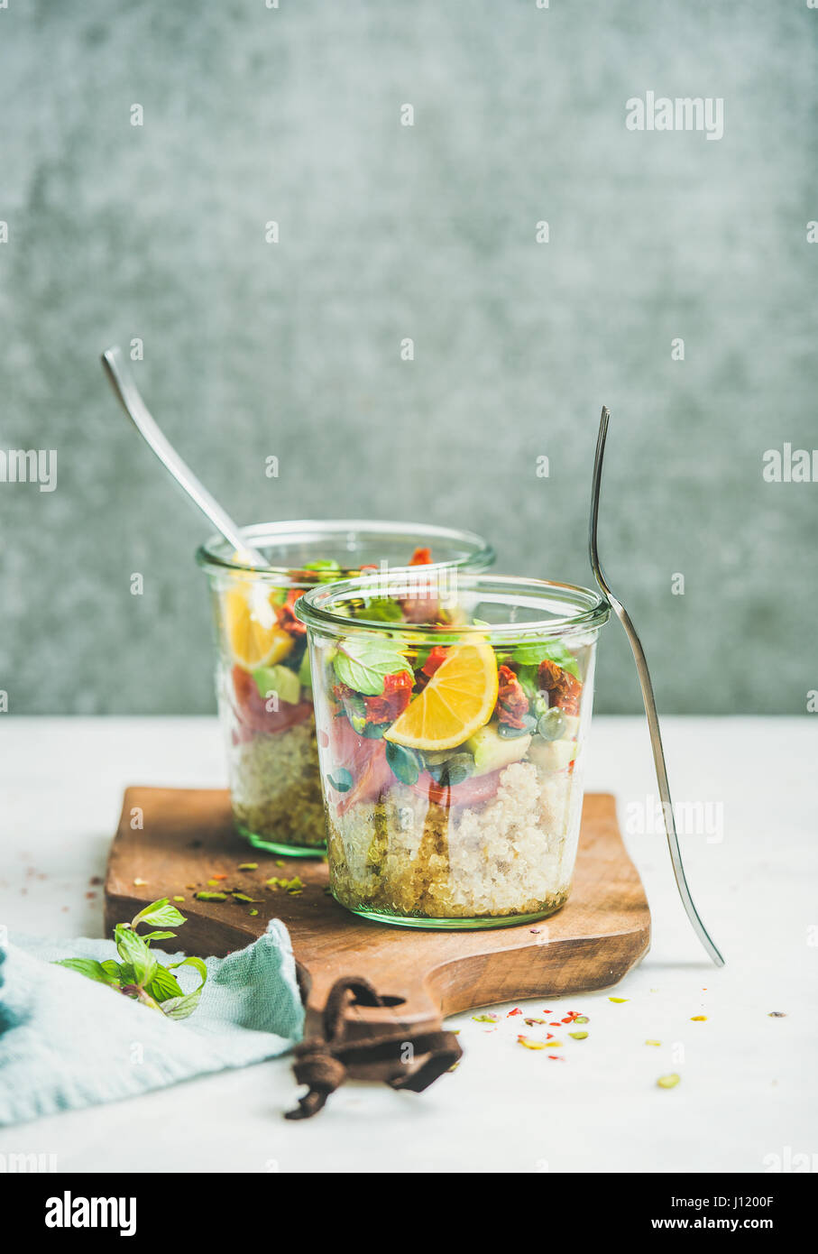 Healthy salad with quionoa, avocado, dried tomatoes, orange and basil Stock Photo