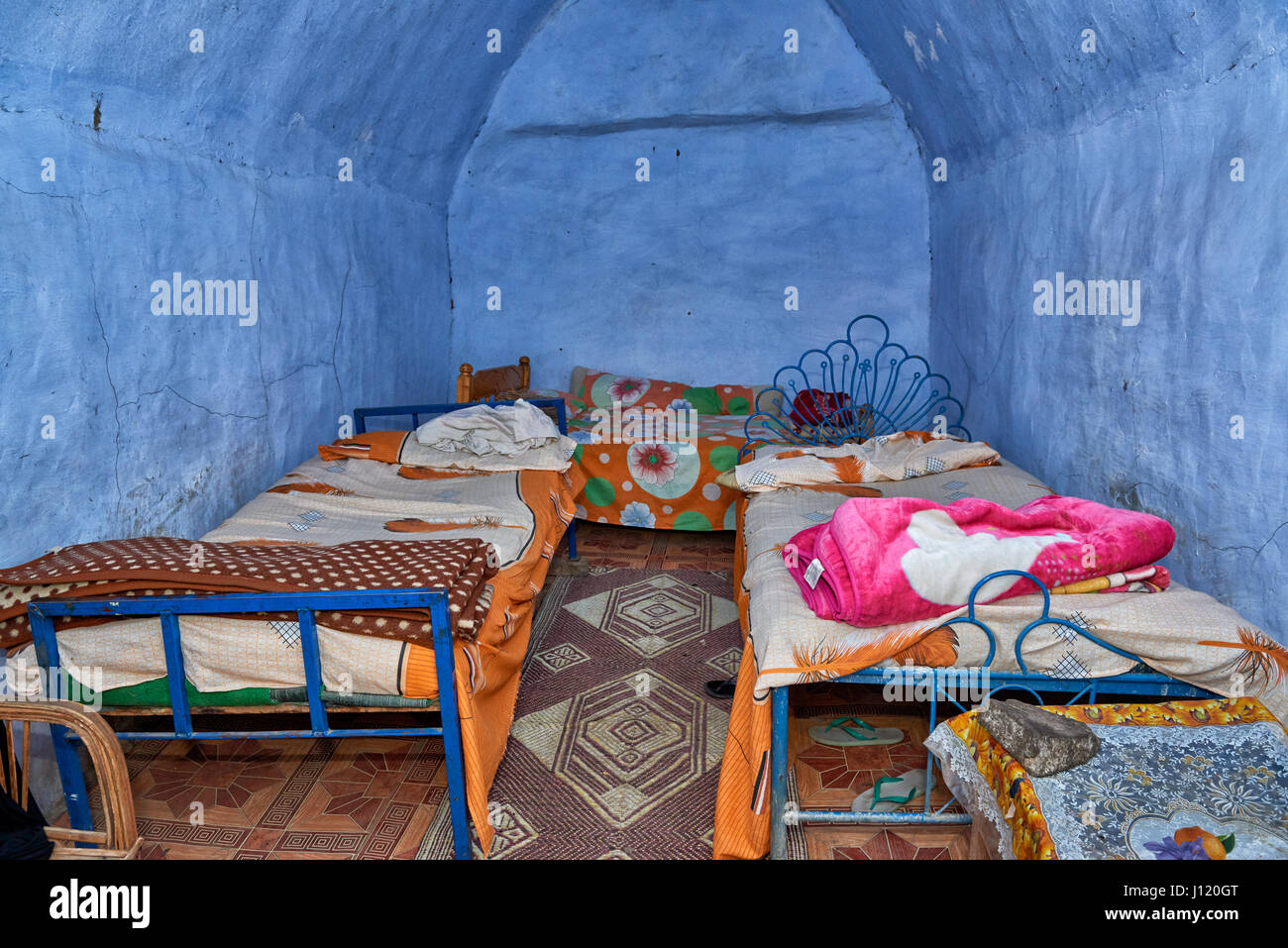 blue painted sleeping room with beds inside house in nubian village near Aswan, Egypt, Africa Stock Photo