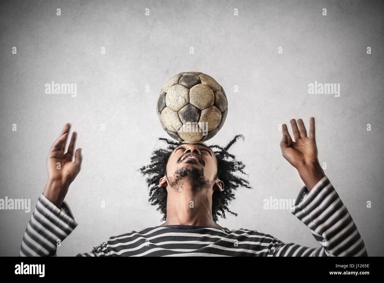 Young black man playing with football Stock Photo