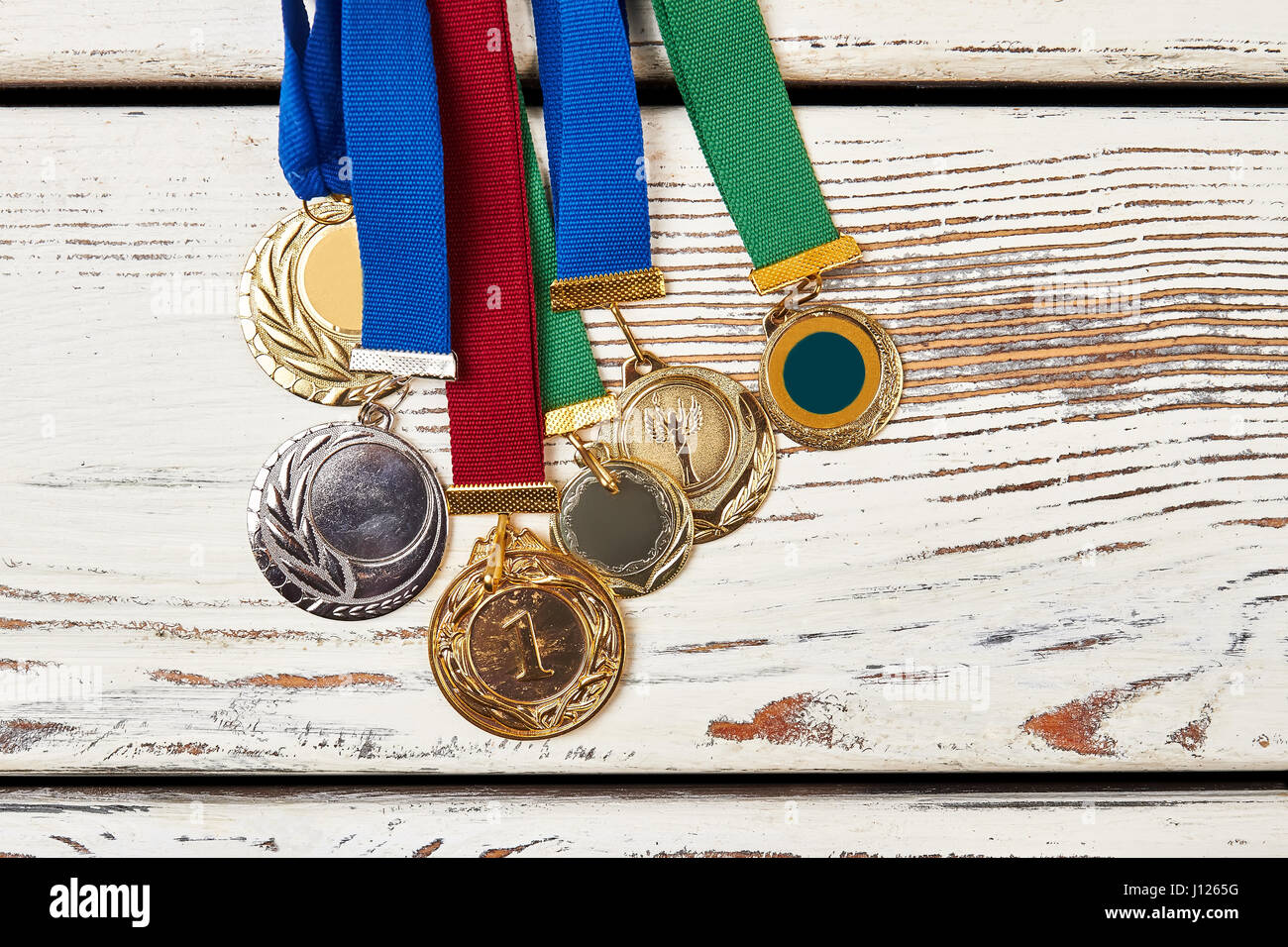Sport medals on wooden background Stock Photo - Alamy