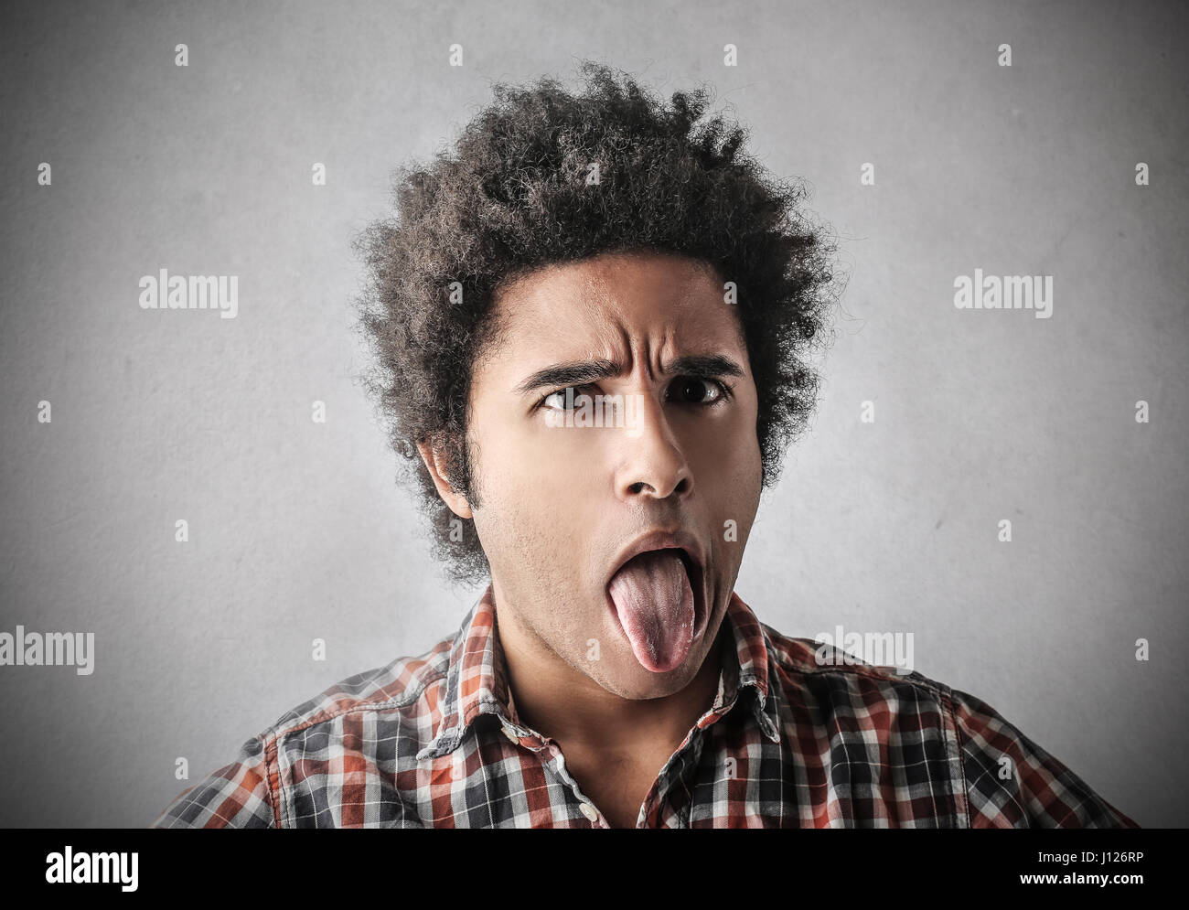 Young boy sticking out his tongue hires stock photography and images