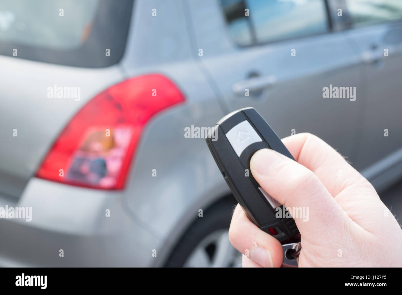 Hand holding a car alarm key with antitheft Stock Photo Alamy