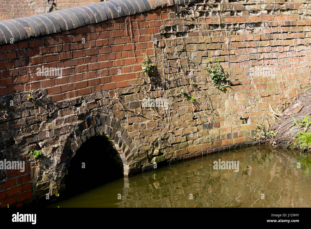 Old Victorian bridge over feeder canal in England Stock Photo