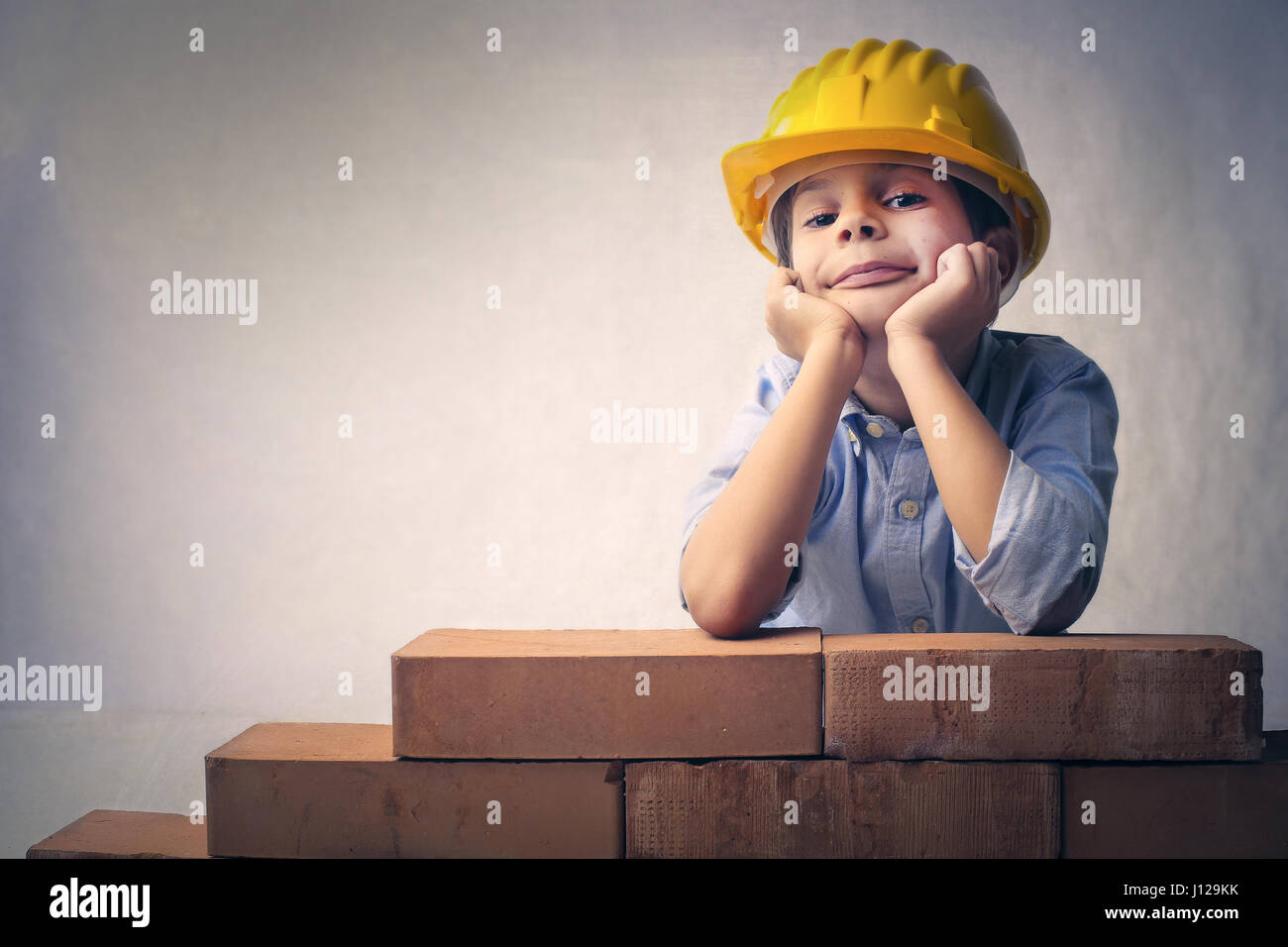 Boy construction worker with bricks Stock Photo
