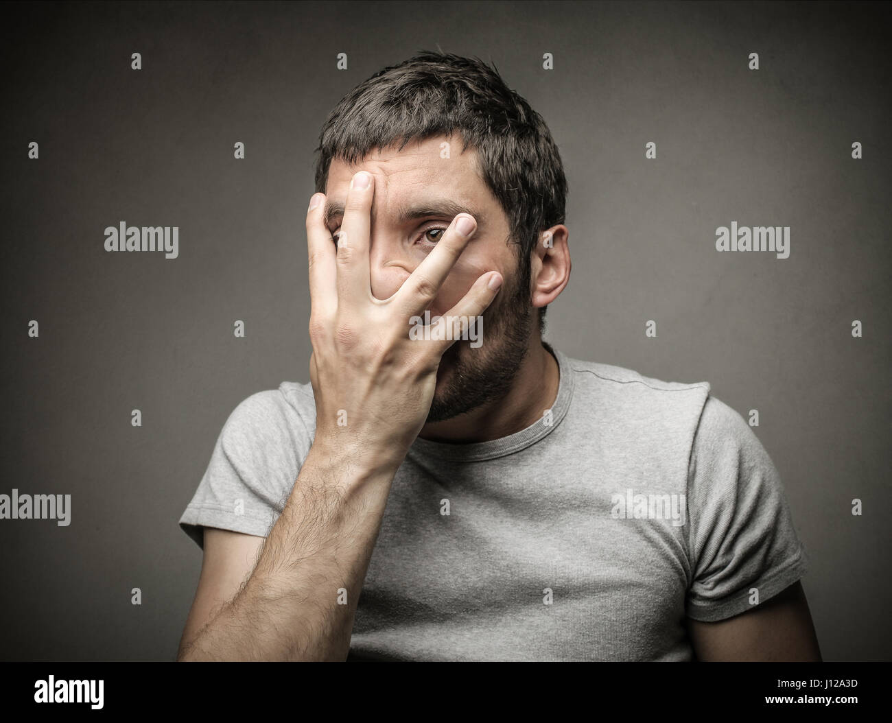 Mad man holding his face Stock Photo