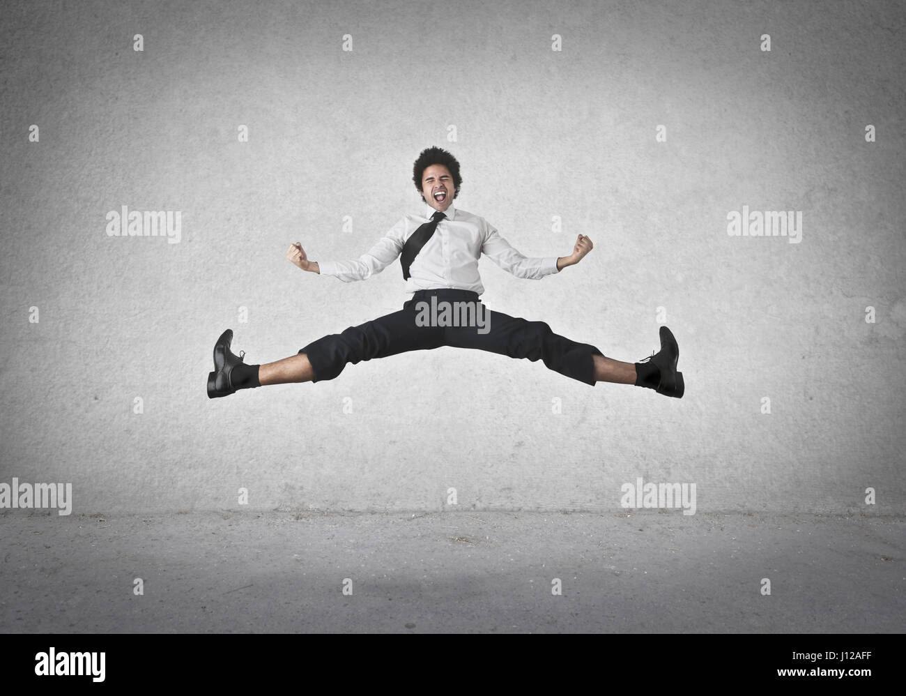 Man jumping and doing a split Stock Photo