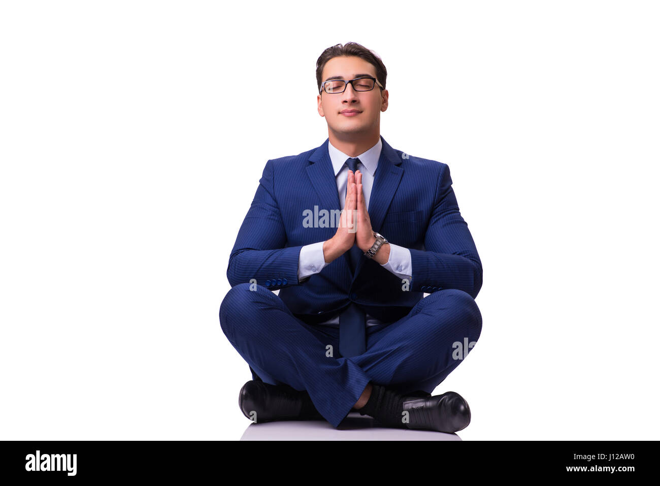 Businessman meditating on the floor isolated on white Stock Photo - Alamy