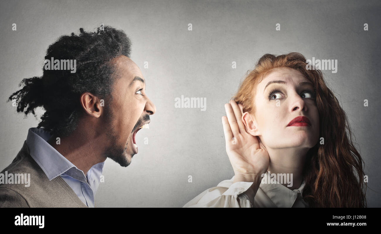 Man yelling at listening woman Stock Photo