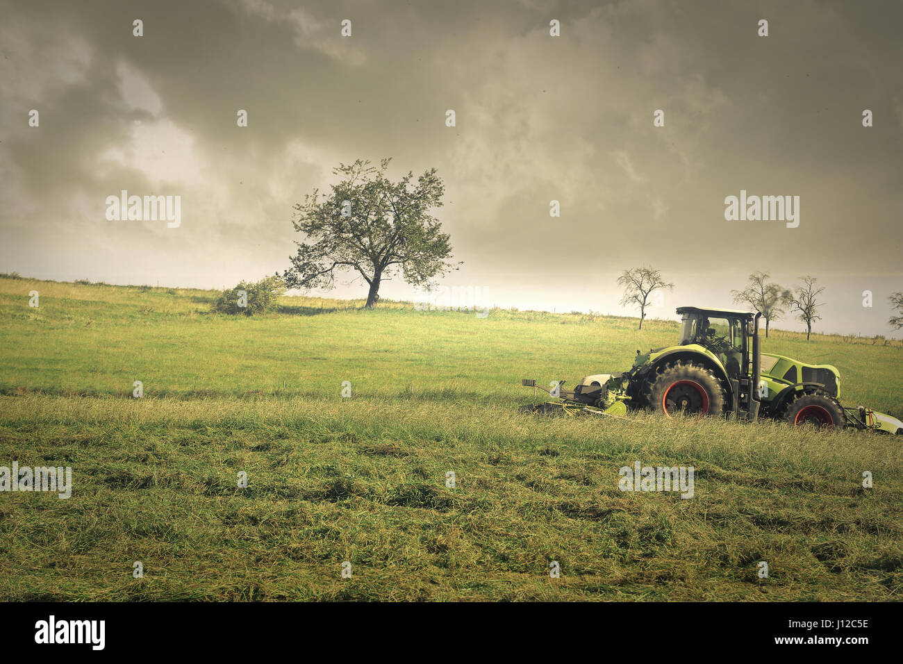 Tractor on field Stock Photo - Alamy