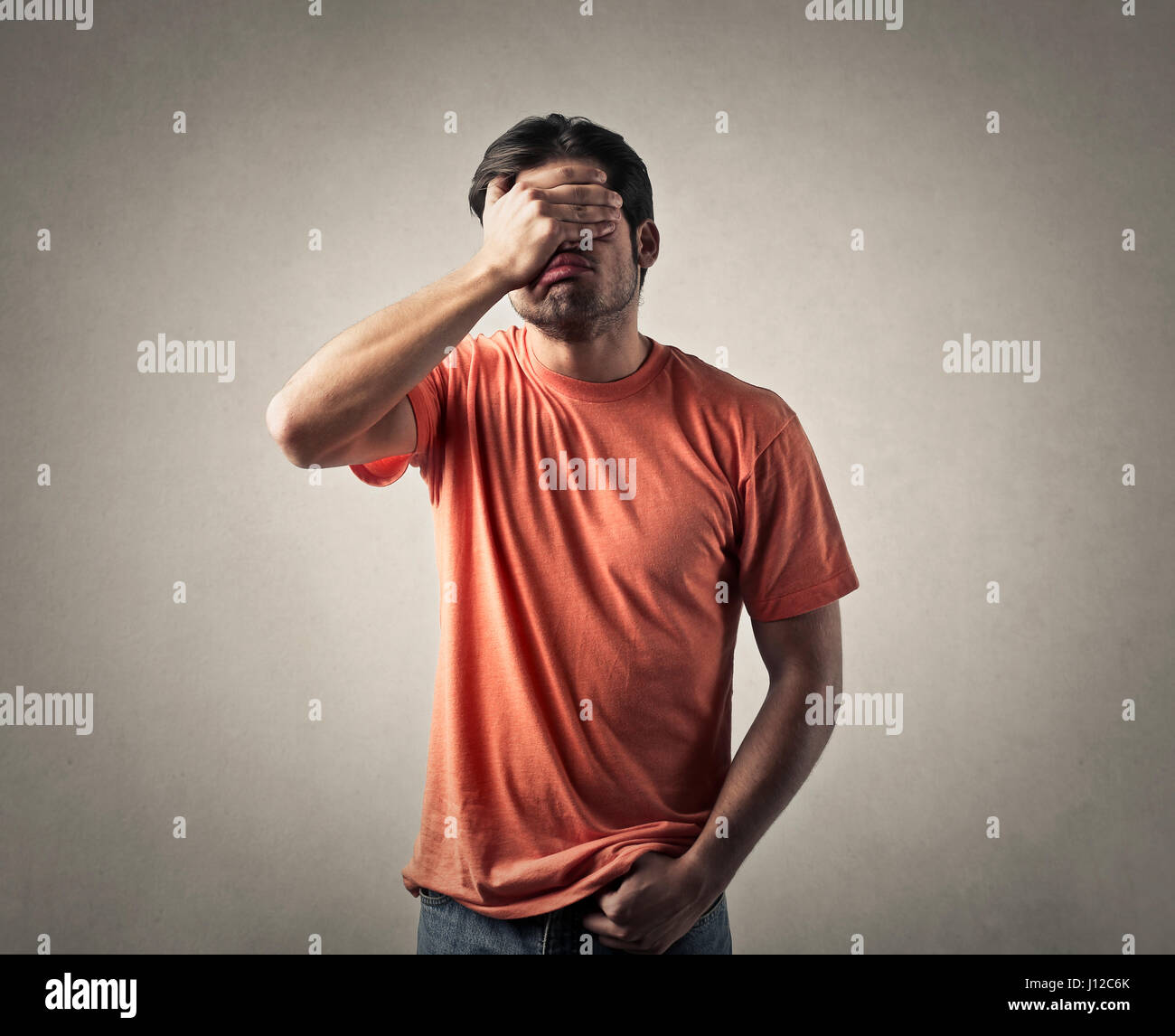 Man holding his face Stock Photo - Alamy