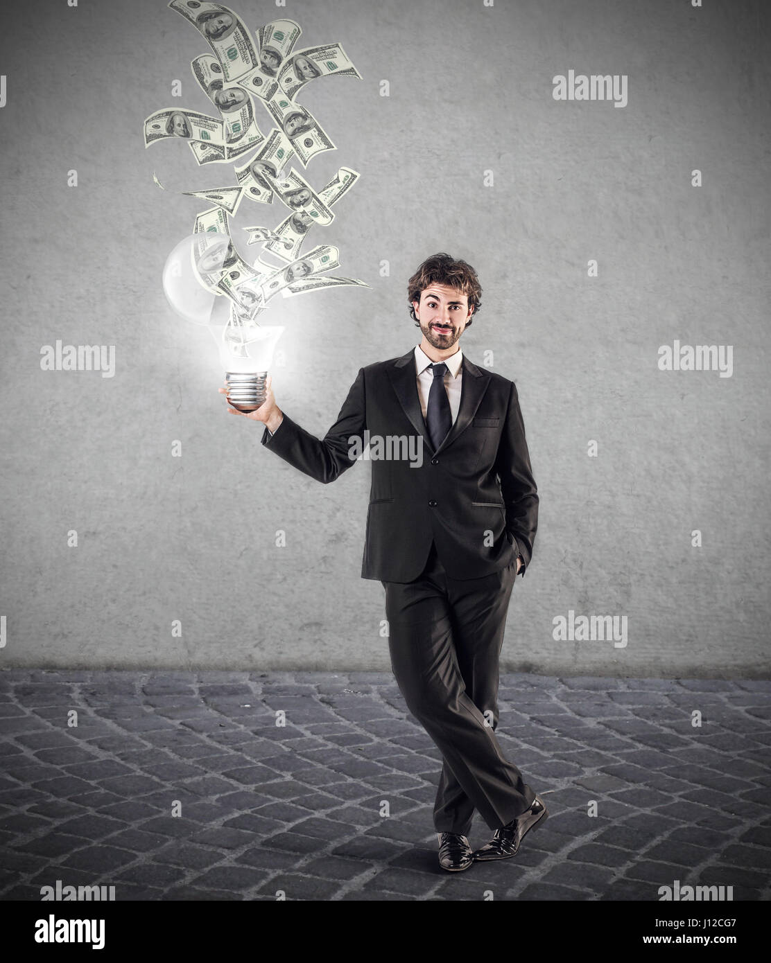 Businessman with lightbulb, money coming out of it Stock Photo