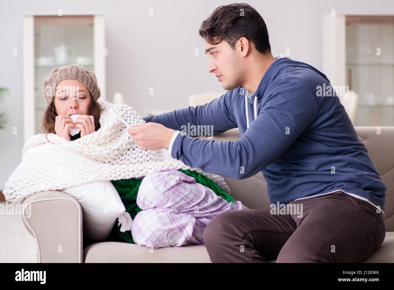 Husband caring for sick wife Stock Photo - Alamy