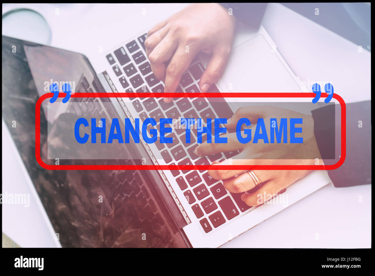 Hand and text  'CHANGE THE GAME' with vintage background. Technology concept. Stock Photo