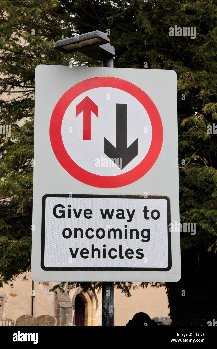 A 'Give way to oncoming vehicles' road sign in the United Kingdom. Stock Photo