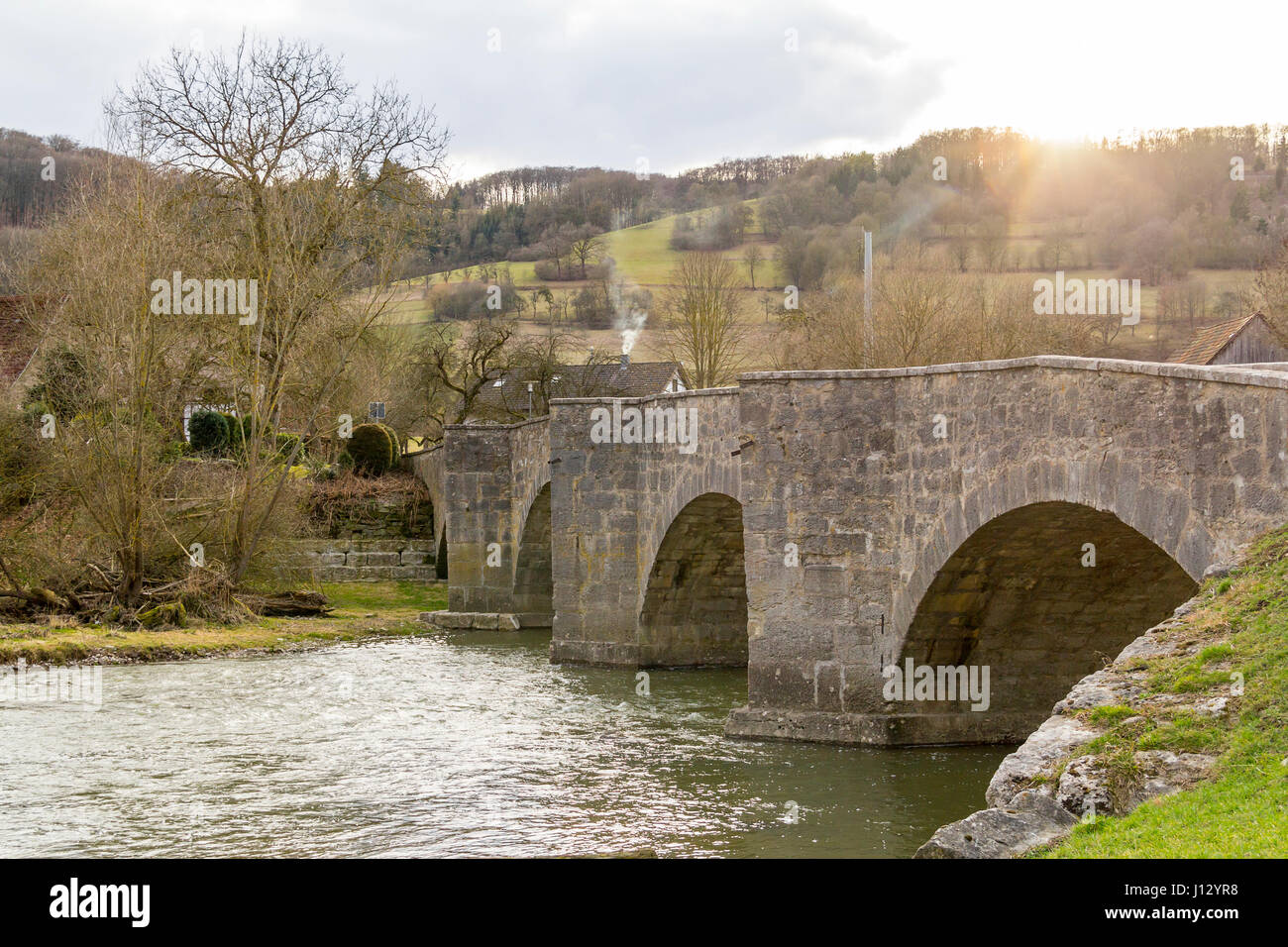 historic stone bridge at a small rural village named Oberregenbach near Langenburg in Hohenlohe, a area in Southern Germany Stock Photo
