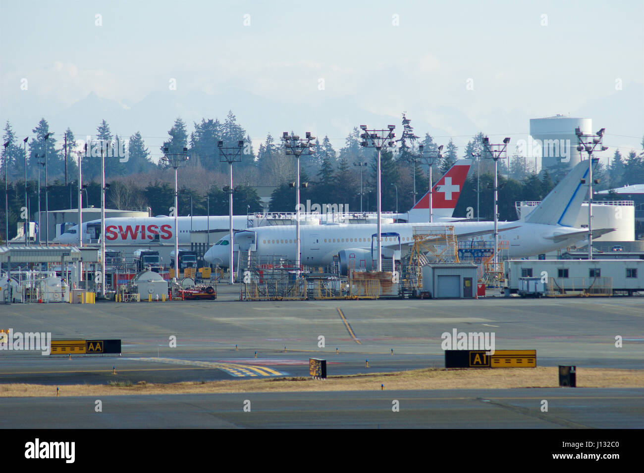 EVERETT, WASHINGTON, USA - JAN 26th, 2017: Boeing production site, the huge factory at Snohomish County Airport or Paine Field, a brand new SWISS B777 and a B787 Dreamliner in the background Stock Photo