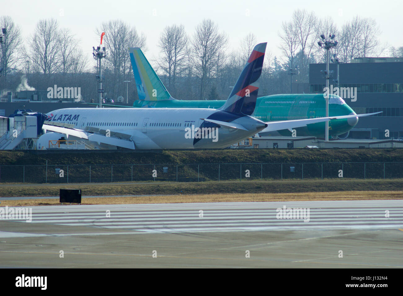 EVERETT, WASHINGTON, USA - JAN 26th, 2017: Boeing production site, the huge factory at Snohomish County Airport or Paine Field, a brand new LATAM B787 Dreamliner and a plaine 747-8 in the background Stock Photo