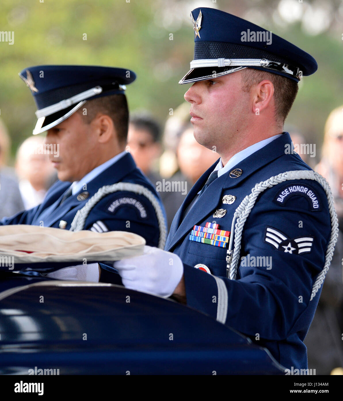 Blue Eagles Honor Guard members Senior Airman Joseph Trujillo (right) and Senior Airman Archie Daquioag (left) fold a flag over the casket of retired U.S. Air Force Master Sgt. Johnny B. Hillary while performing funeral honors Jan. 14, 2016, at Riverside National Cemetery in Riverside, California. Hillary was an Air Force Junior ROTC instructor and also served in the California State Military Reserve as a chaplain assistant attached to the California Air National Guard's 163d Attack Wing. (Air National Guard Photo by Airman 1st Class Crystal Chatham Housman)(Released) Stock Photo