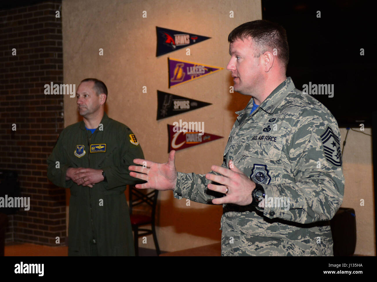 Col. Gentry Boswell, 28th Bomb Wing commander, and Chief Master Sgt. Adam Vizi, 28th Bomb Wing command chief, speak on the importance of the Air Force Assistance Fund inside the Dakota’s Cub at Ellsworth Air Force Base, S.D., March 31, 2017. If interested in donating contact a unit AFAF representative. For more information on the different charities, call (800) 258-1413 for Air Force Enlisted Village, (800) 554-5510 for the General and Mrs. Curtis E. LeMay Foundation, (800) 655-3083 for Air Force Villages Indigent Widows' Fund, and (703) 972-2650 for Air Force Aid Society. (U.S. Air Force phot Stock Photo