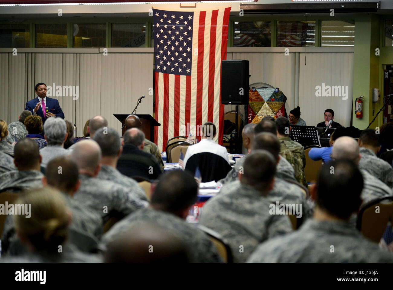 Kelly Wright, a pastor and news anchor for Fox News Channel, speaks to Airmen assigned to the 105th Airlift Wing and others during a prayer breakfast hosted by the 105th Airlift Wing’s chaplain’s office at Stewart Air National Guard Base, New York March 31, 2017.  Wright, an Army veteran, spoke on a variety of topics and sang gospel songs. Stock Photo