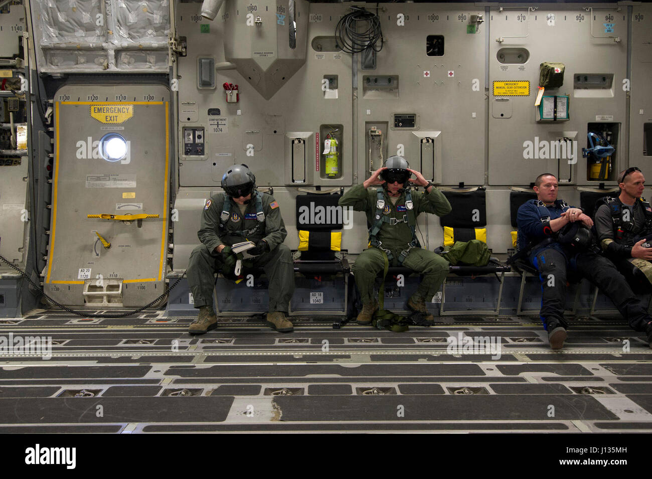 Loadmasters from the 701st Airlift Squadron review checklists and ...