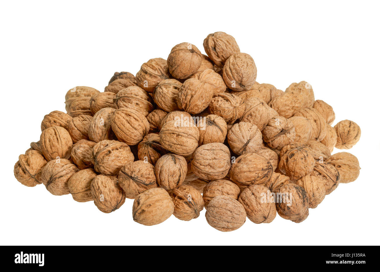 pile of walnuts with nutshell in white back Stock Photo