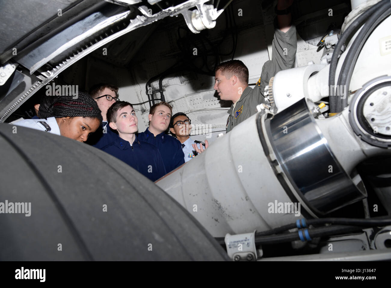 Senior Airman Levi Grant, a loadmaster assigned to the 105th Airlift Wing, shows cadets from the Newburgh Free Academy Junior Reserve Officer Training Corps program the inside of a C-17 Globemaster III wheel well during a tour at Stewart Air National Guard Base April 3, 2017. More than 40 cadets attended the special tour of the base. (U.S. Air Force photo by Staff Sgt. Julio A. Olivencia Jr.) Stock Photo
