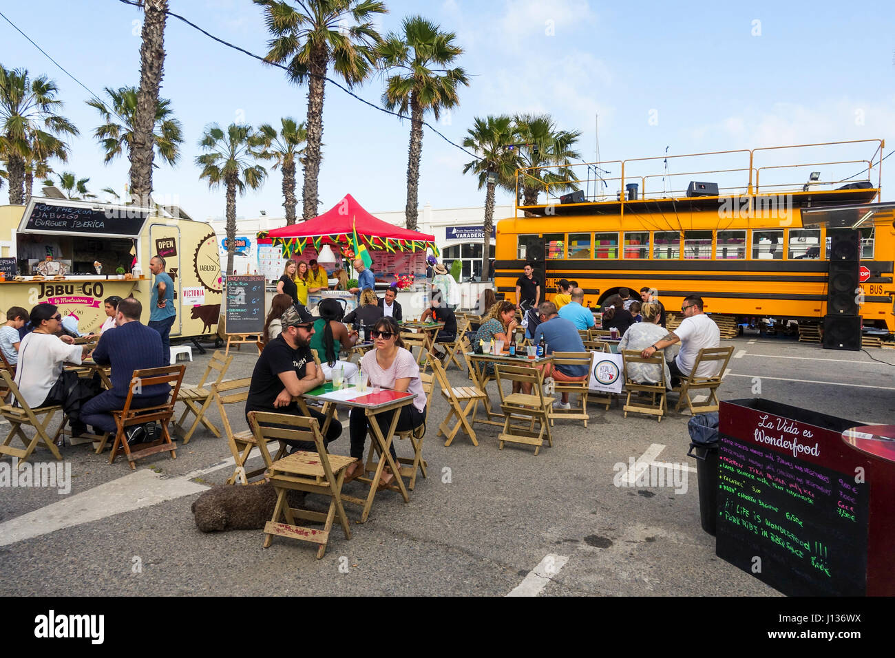 People eating at terrace Food trucks at festival, festive, celebration in Port of Benalmadena, Andalusia, Spain Stock Photo