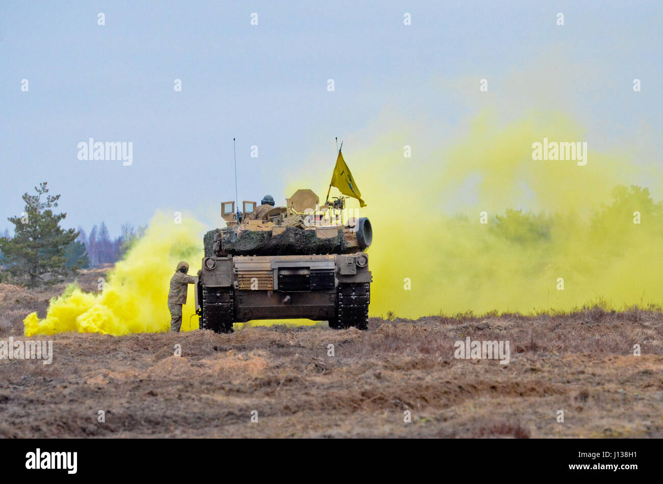 Ādaži, Latvia - Soldiers from Company A, 1st Battalion, 68th Armored Regiment, 3rd Armored Brigade Combat Team, 4th Infantry Division, out of Fort Carson, Colo., conduct a tank live-fire and react-to-fire exercise on Ādaži military base as a part of Operation Atlantic Resolve, April 9. This live fire was part of a platoon-level training exercise to familiarize Soldiers with local terrain as well as how to react under pressure to situations such as loss of communication with higher headquarters, loss of global positioning system and chemical attack. The 3rd ABCT is trained to operate in any env Stock Photo