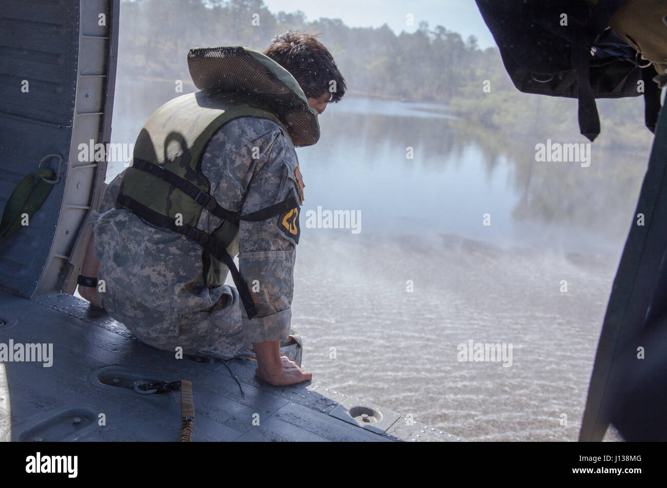A Ranger from the 25th Infantry Division jumps from a UH-60 Black Hawk ...