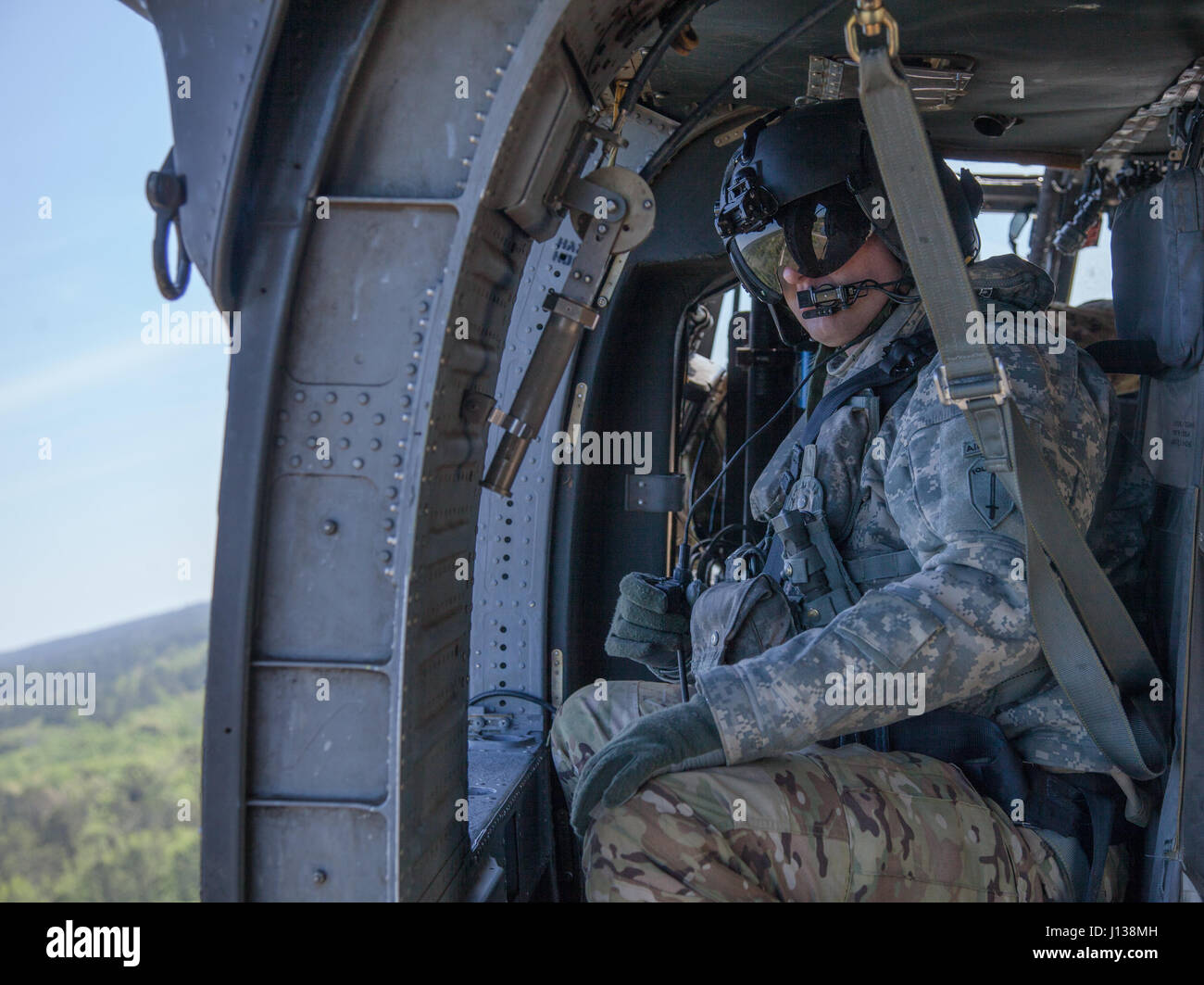 A U.S. Army UH60 Black Hawk helicopter crew member observes the