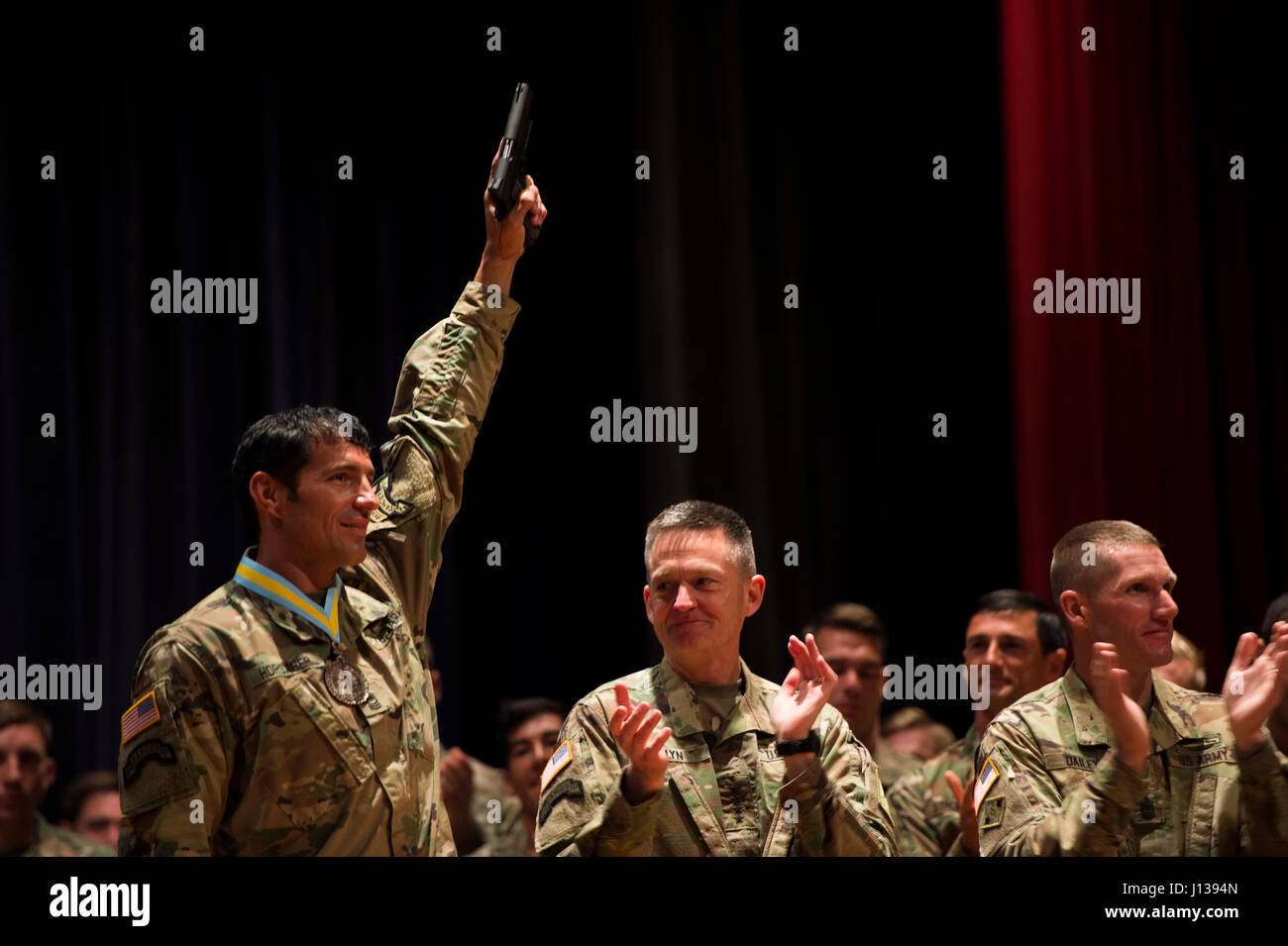 U.S. Army Master Sgt. Josh Horsager, 75th Ranger Regiment, hoists his pistol into the air during an award ceremony recognizing him as one of the Army's best Rangers at Fort Benning, Ga., April 10, 2017. The Colt M1911s are awarded to the winners of the competition each year.  (U.S Army Photo by Spc. Kristen Dobson) Stock Photo