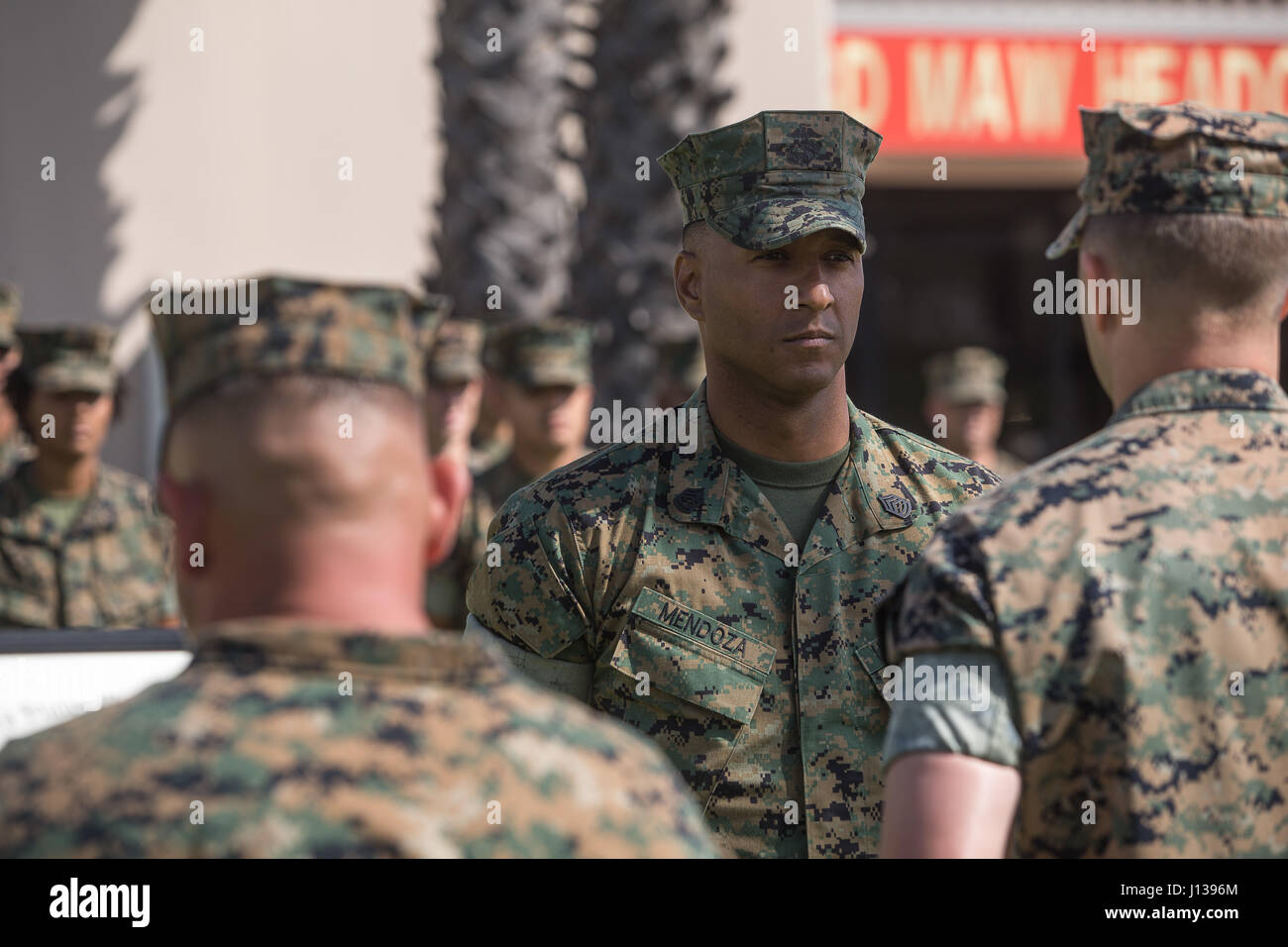 U.S. Marine Corps Gunnery Sgt. Anthony Mendoza, anti-terrorism and force protection chief for 3rd Marine Aircraft Wing (3dMAW), G-3 Operations, receives the promotion to Master Sergeant at the 3dMAW Headquarters building at Marine Corps Air Station Miramar San Diego, Calif., April 10, 2017.  Mendoza’s fellow Marines assigned to 3dMAW, G-3 Operations, stand in formation behind him as part of a traditional promotion ceremony in which, they will congratulate him for his success – afterward.  (USMC photo by Staff Sgt. Jon Spencer) Stock Photo