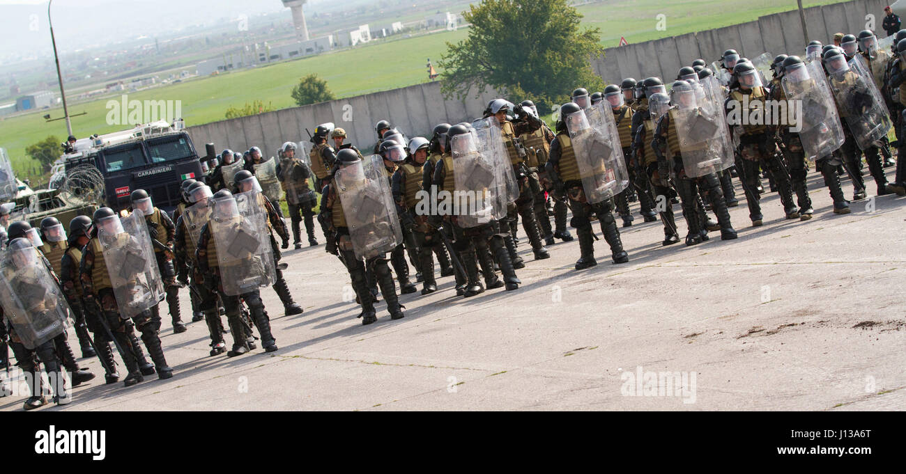 Multinational soldiers of Kosovo Force stand ready as they begin their ...